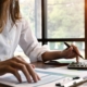 A businesswoman at a desk calculating